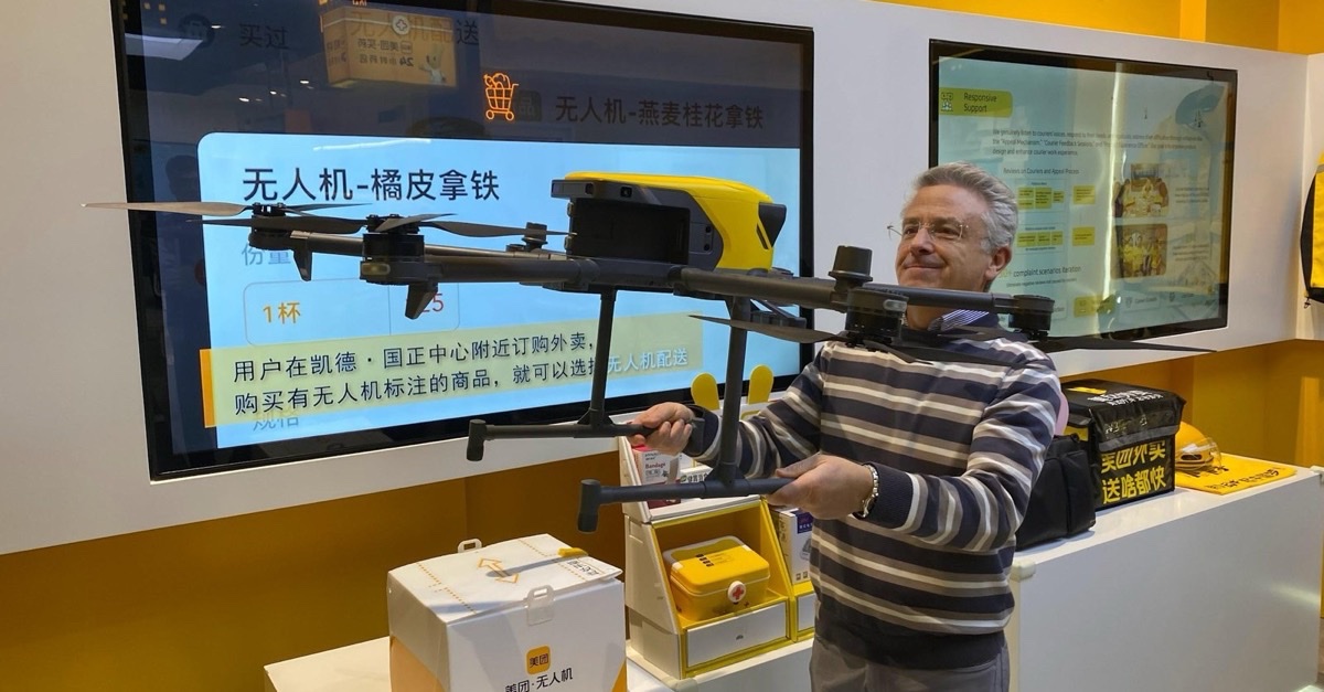 Benedetto Conversano holding a delivery drone on display in China